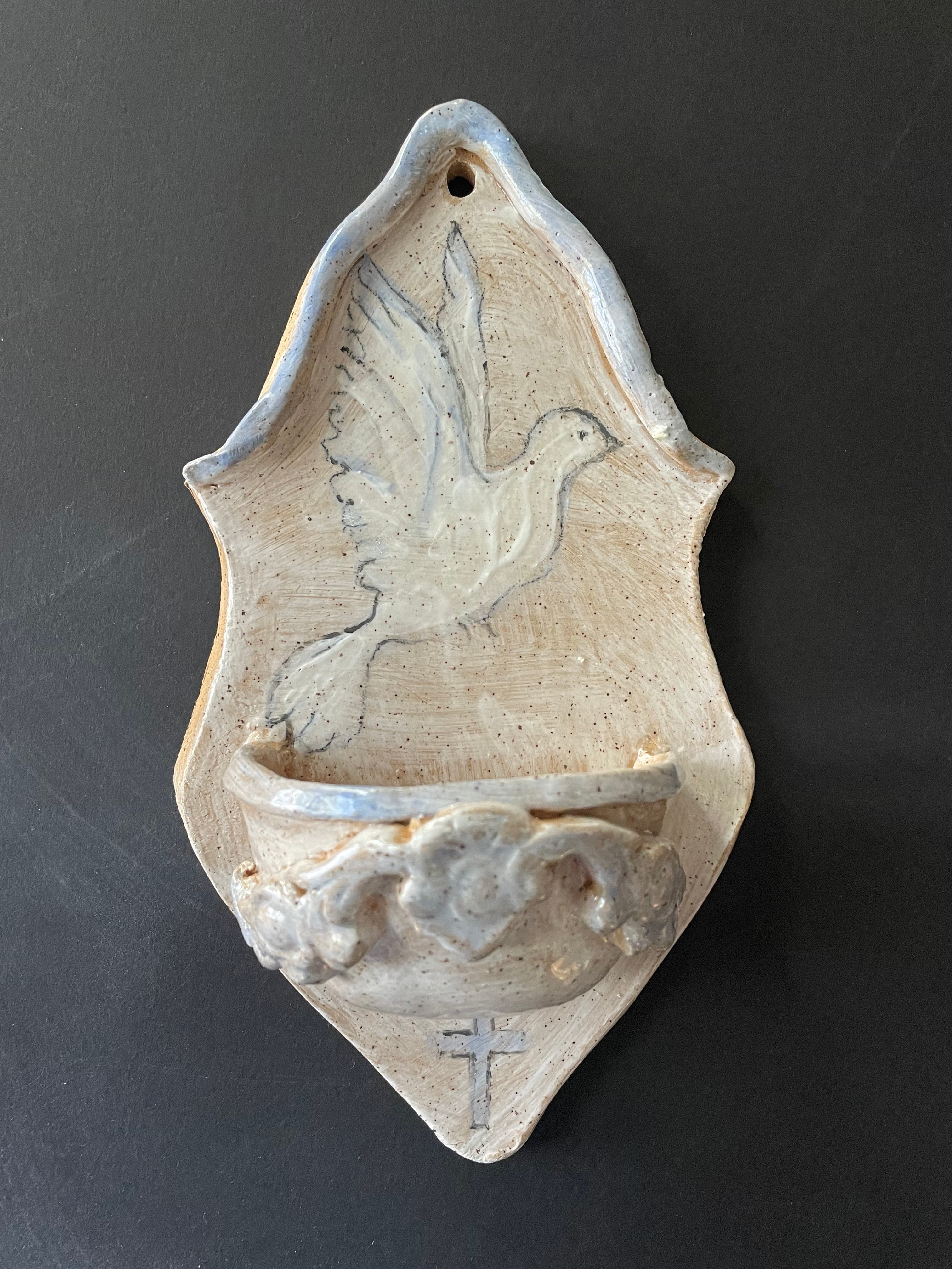 Holy water font with dove